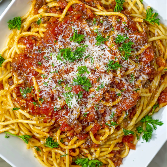 A bowl of spaghetti and meat.