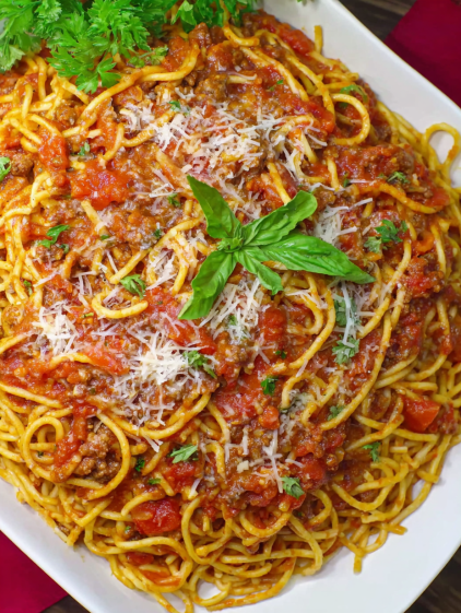 A plate of spaghetti with meat sauce and cheese.