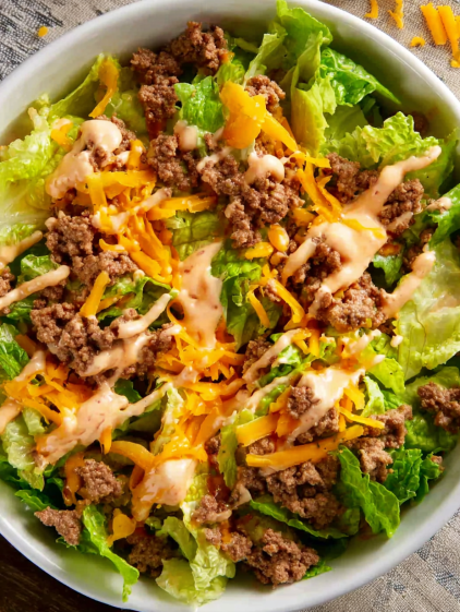 A salad with cheese and meat.