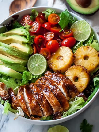 A bowl of food with chicken, pineapple, tomatoes, and avocado.