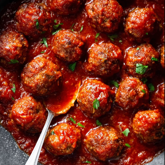 A bowl of meatballs in a red sauce.