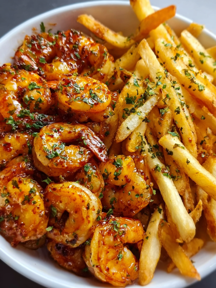 A plate of shrimp and french fries.
