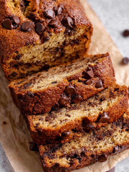 A slice of chocolate cake with chocolate chips.