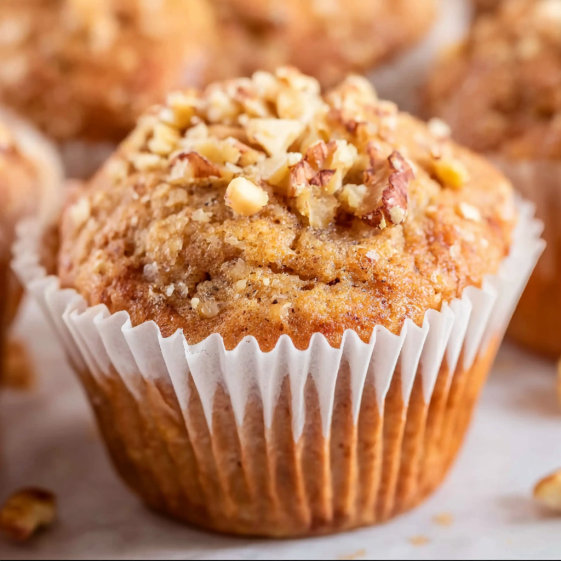 A cupcake with nuts on top.