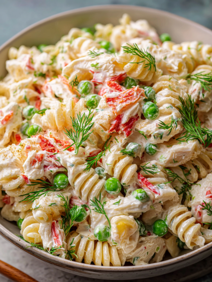A bowl of pasta with peas and chicken.