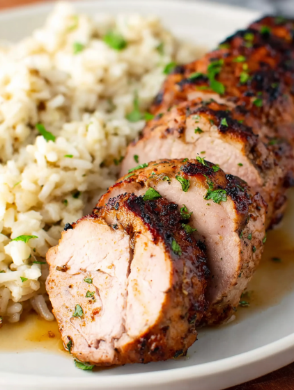 A piece of meat with rice and green onions.