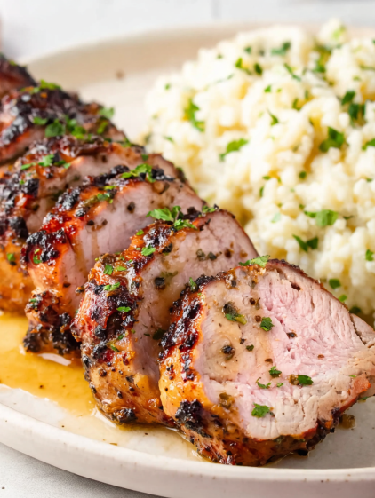 A plate of food with meat and rice.