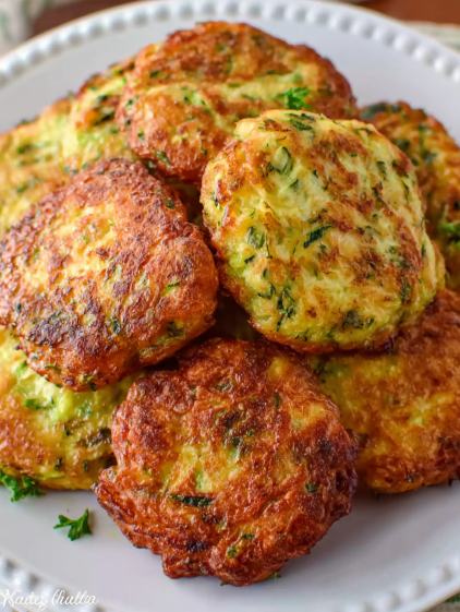 Air fryer zucchini fritters on a plate.