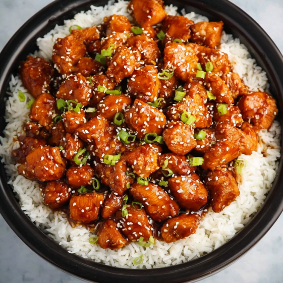 A bowl of chicken with rice.
