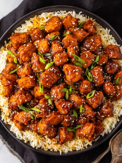 A plate of chicken with rice and vegetables.