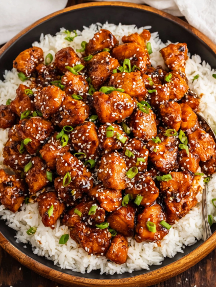 A plate of chicken with rice and vegetables.