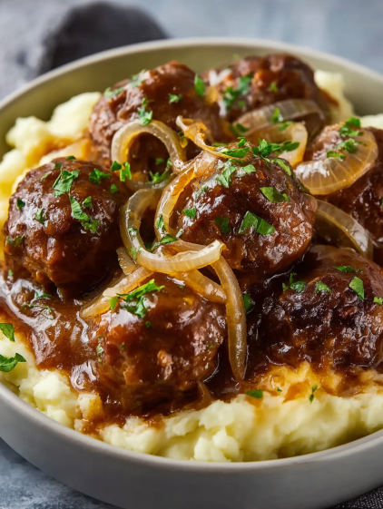 A bowl of slow cooker French onion meatballs.