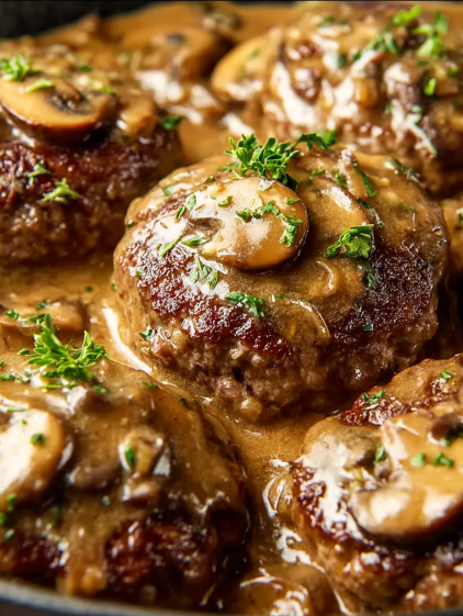 A plate of meatballs covered in gravy.