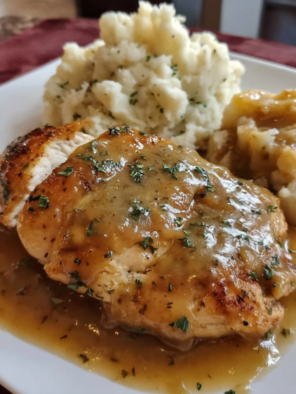 A plate of food with chicken and potatoes.
