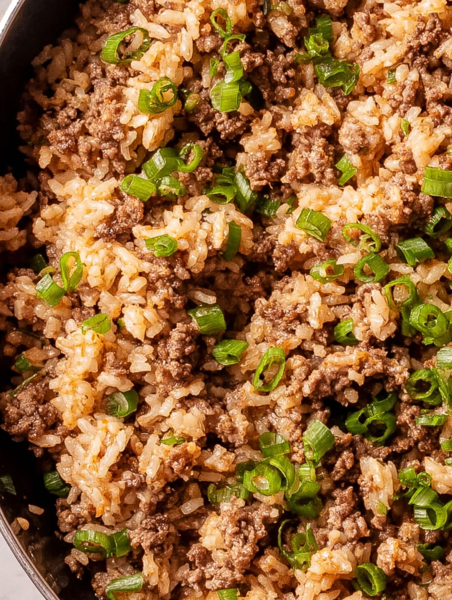 A bowl of rice with meat and vegetables.