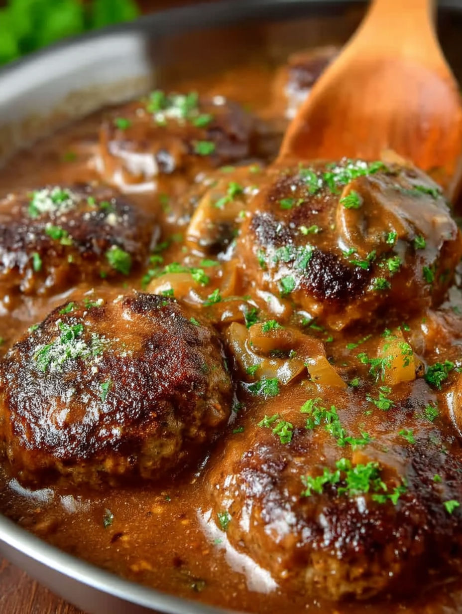 A bowl of meatballs in a brown sauce.