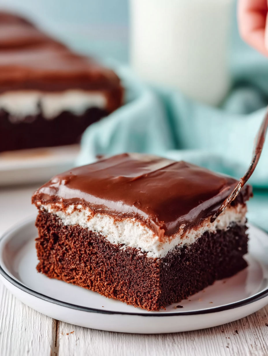 A slice of chocolate cake with white frosting.