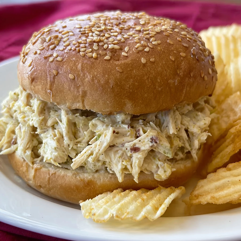 A sandwich with shredded chicken on a bun.