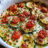 A cheesy zucchini bake with tomatoes and herbs.