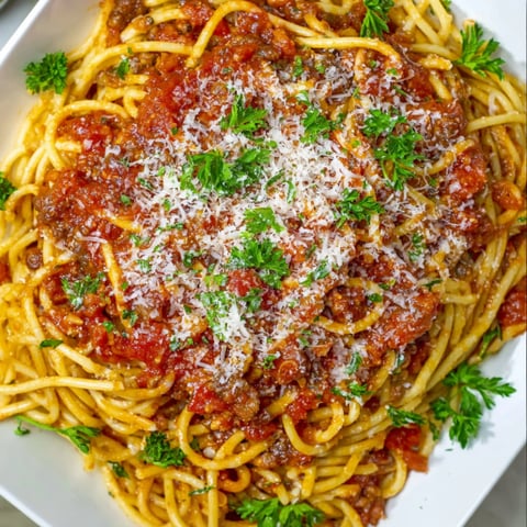 A bowl of spaghetti and meat.