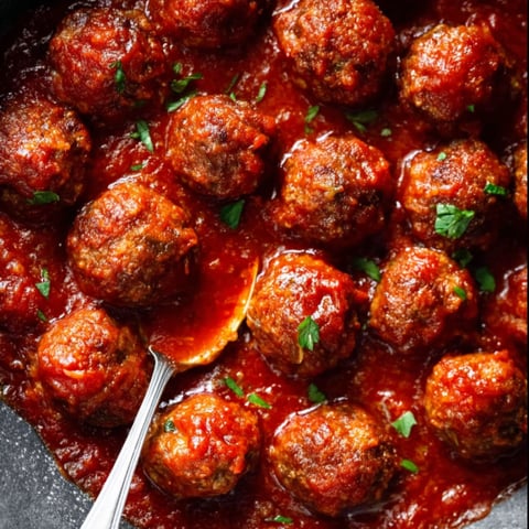 A bowl of meatballs in a red sauce.