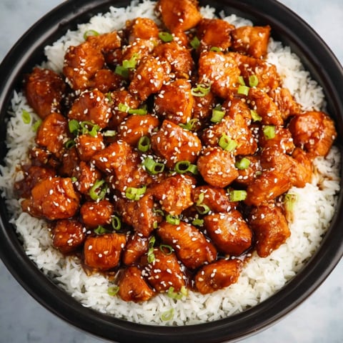 A bowl of chicken with rice.