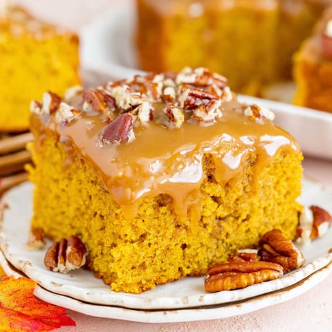 A slice of pumpkin snack cake with praline topping.