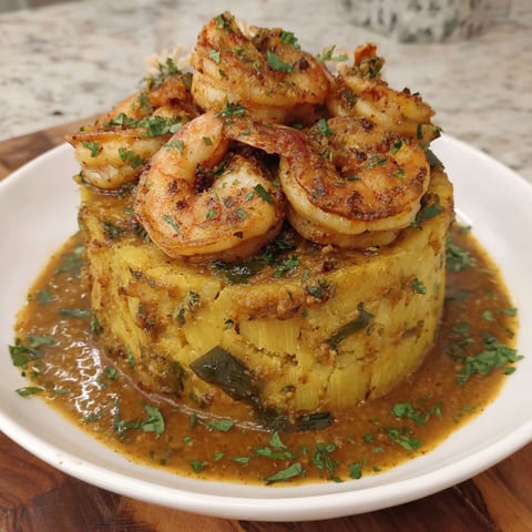 A plate of food with shrimp and garlic butter.