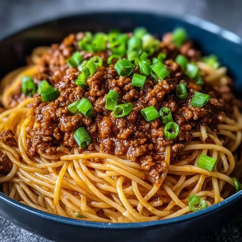 A bowl of Asian ground beef noodles.
