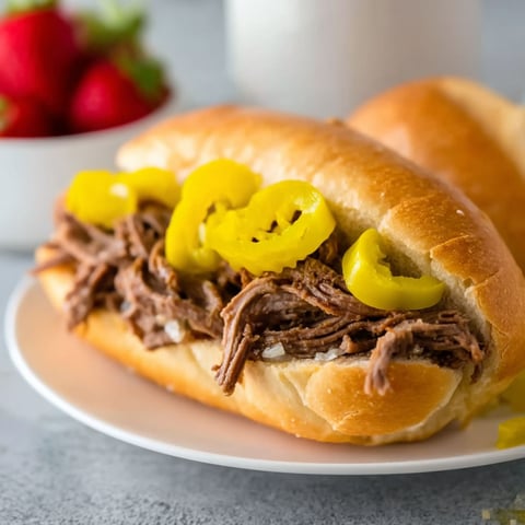 A sandwich with peppers and cheese on a plate.