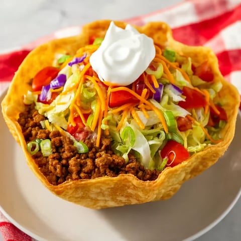 A Taco Bell Taco Salad with lettuce, tomatoes, and cheese.