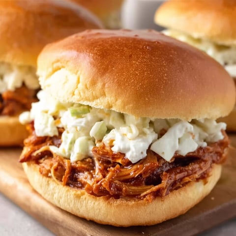 A sandwich with pulled pork and coleslaw.
