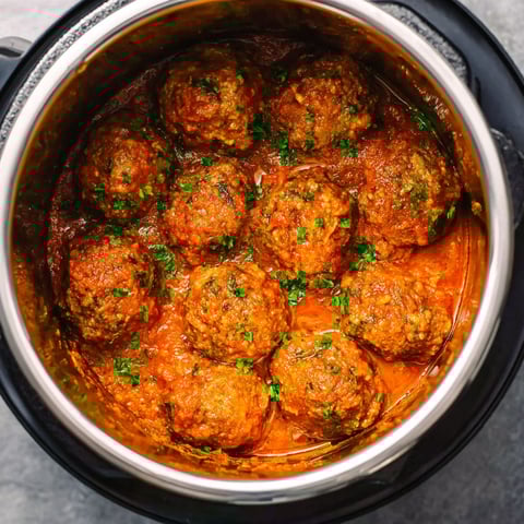 A pot of meatballs in a sauce.