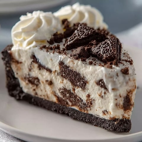 A slice of cheesecake with chocolate and white frosting.